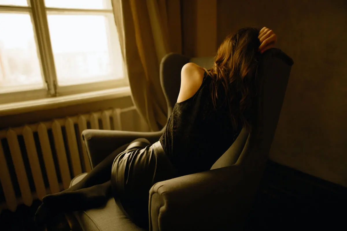 A depressed woman sitting in a chair