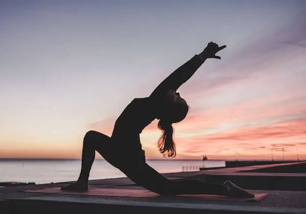 A woman practicing yoga to enhance mental clarity, brain health, and physical well-being